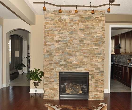 Fireplace installation from natural stone bricks in the living room