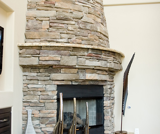 Stone Fireplace installation in the corner of a living room