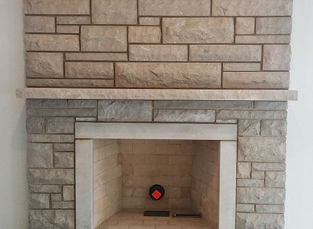 Fireplace installation using different sized beige bricks
